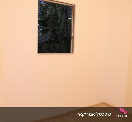 חדר ריק מרהיטים עם קירות ותקרה צבועים בלבן וחלון